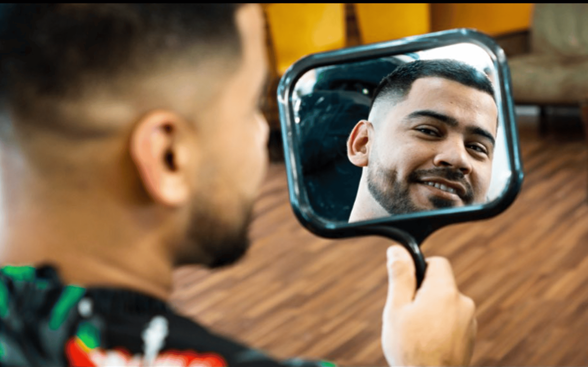 A customer looking at his new haircut in the mirror
